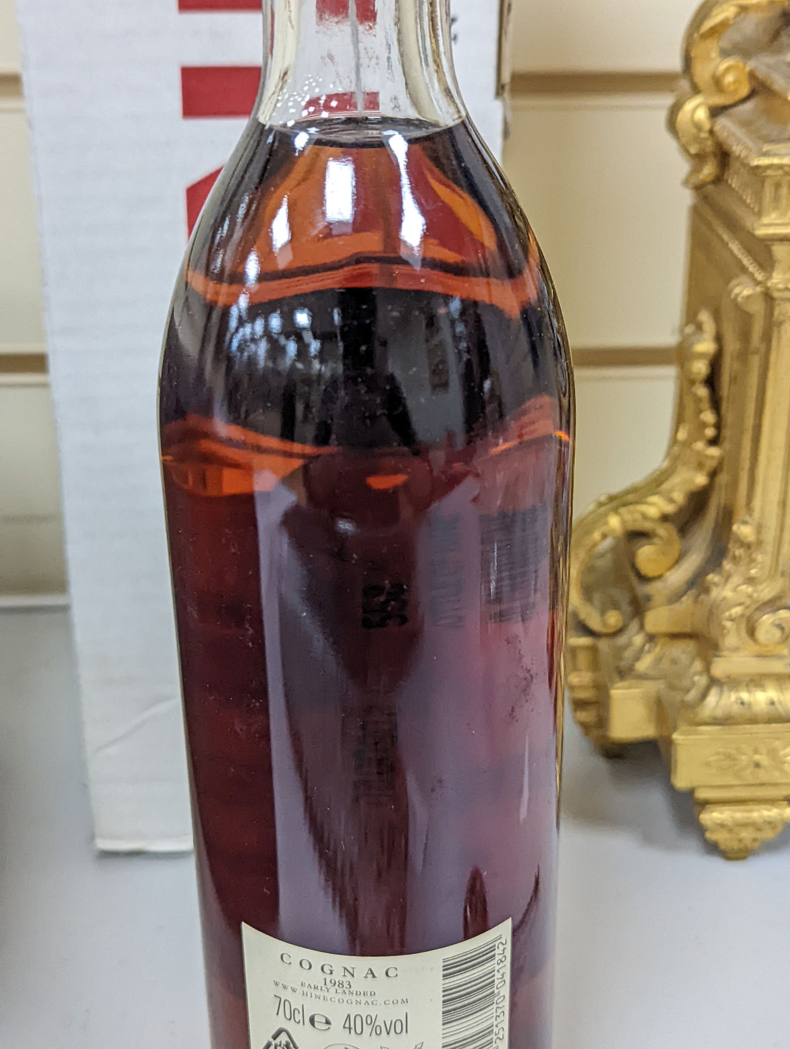 One bottle of Hine Grand Champagne Cognac, 1975. Original cardboard box.